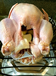 My turkey stuffed with bay leaves, some butter rub, halved onions (I quartered mine because I'm a cheater)